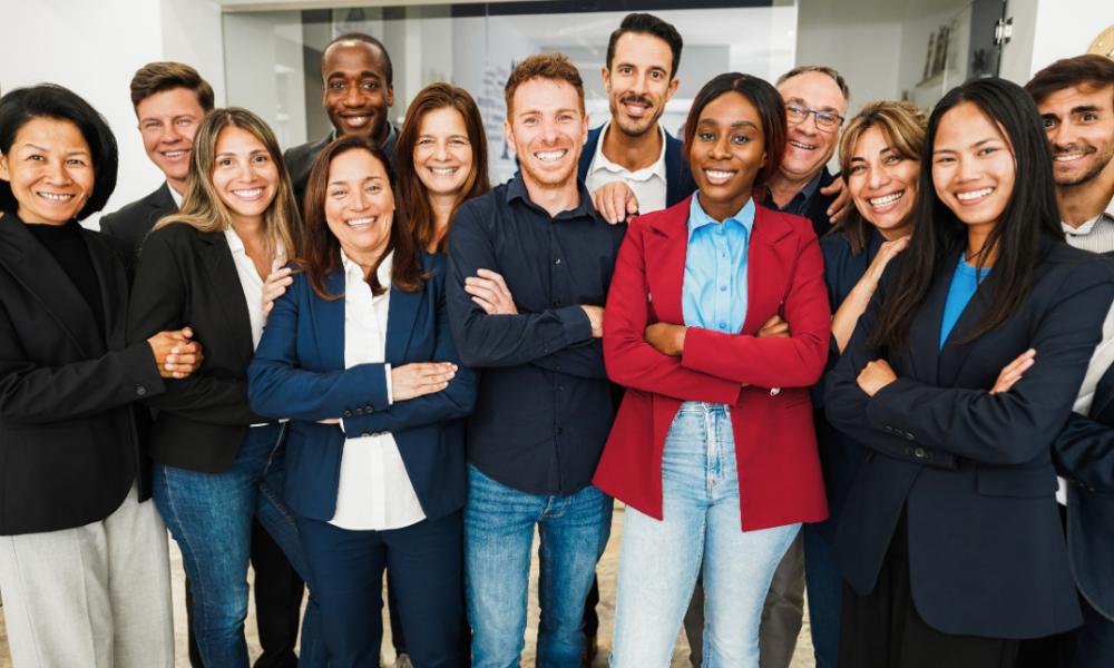 multigenerational-workers-smiling-in-front-of-came-2025-02-22-17-06-09-utc (1)